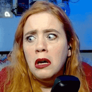 a woman with red hair making a funny face with her mouth open