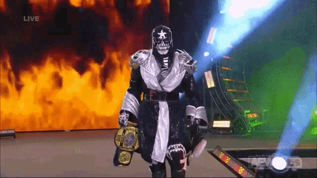 a wrestler is walking down the aisle holding a world heavyweight wrestling championship belt