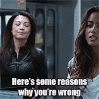 two women are standing next to each other and one of them is talking about why she is wrong .