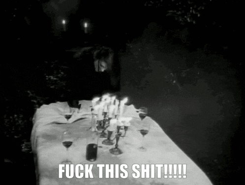 a black and white photo of a table with candles and wine glasses with the caption " fuck this shit !!! "