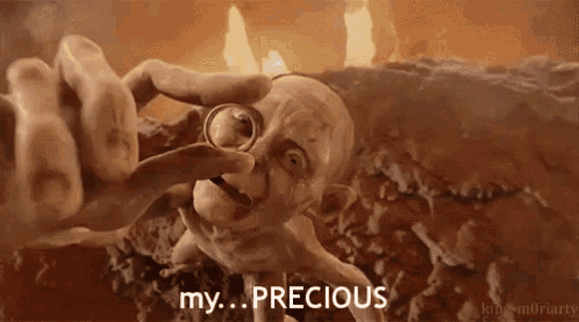 gollum from the lord of the rings is holding a ring in his hand and says `` my precious '' .