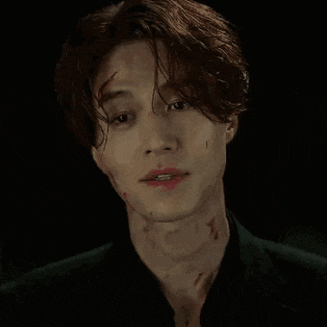 a close up of a man 's face with blood on his neck .