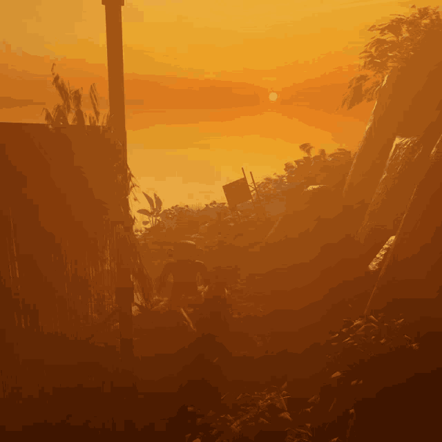 a sunset with a silhouette of a person standing in the foreground