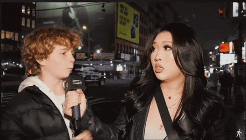 a man and a woman are talking in front of a calvin klein ad