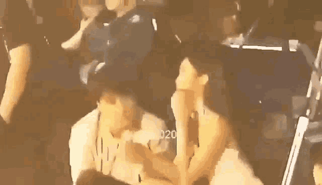 a man and woman are kissing in a crowd at a concert .