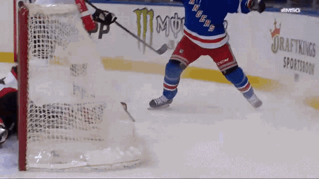 a hockey player wearing a jersey that says rangers on the front