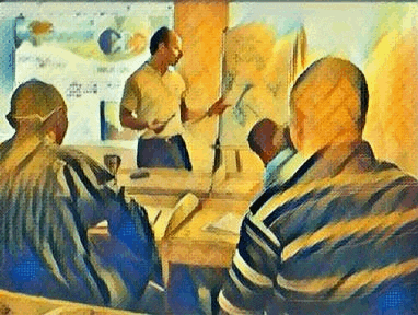 a man is giving a presentation to a group of people sitting at a table .