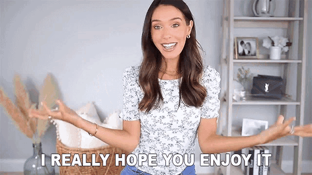 a woman is standing in a living room with her arms outstretched and says i really hope you enjoy it