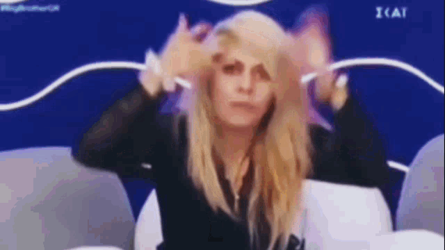 a woman is making a funny face while sitting in a chair .