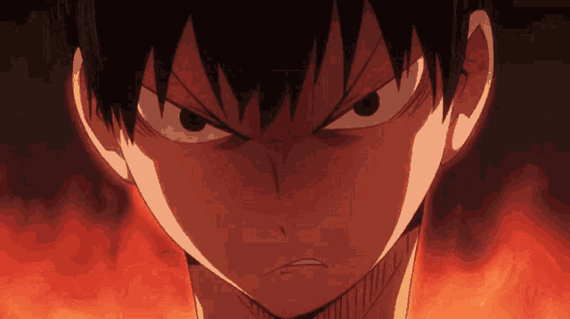 a close up of a boy 's face with an angry expression