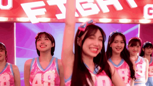 a group of cheerleaders wearing number 48 uniforms
