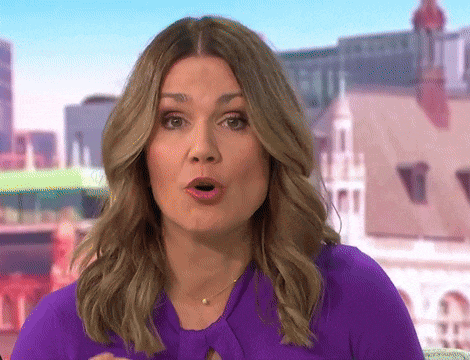 a woman in a purple shirt is making a funny face .