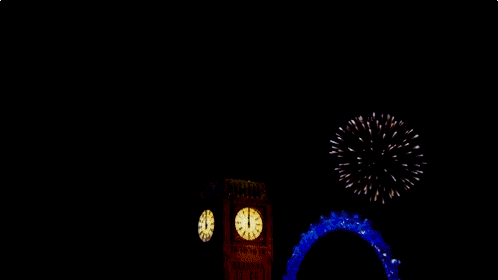 a clock tower is lit up with fireworks behind it