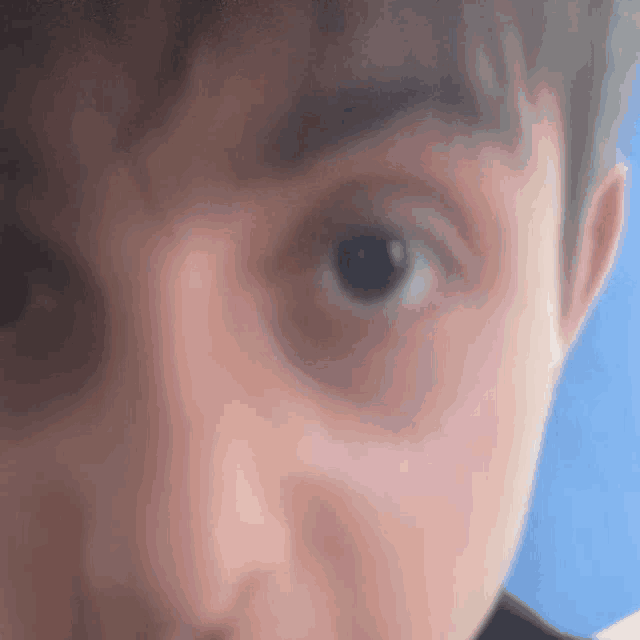 a close up of a person 's face with a blue background .