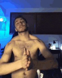 a shirtless man is making a thumbs up sign