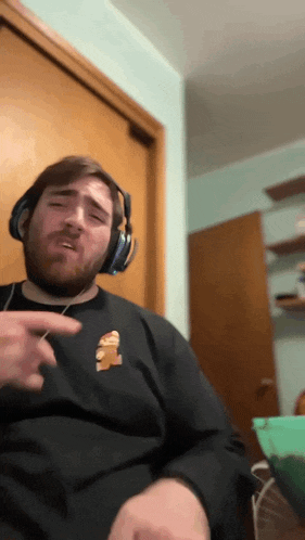a man with a beard wearing headphones and a shirt with a pizza on it