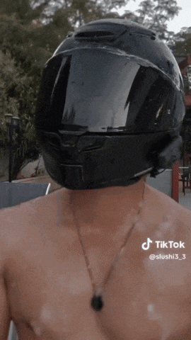 a man without a shirt is wearing a helmet on his head