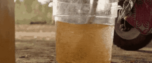 a close up of a cup of liquid with a straw .