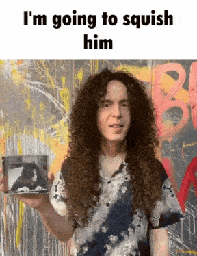 a man with curly hair is holding a cd and the caption says i 'm going to squish him
