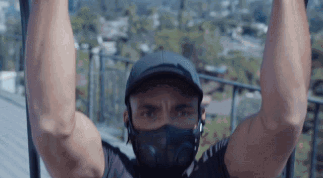 a man wearing a mask and a hat is doing exercises