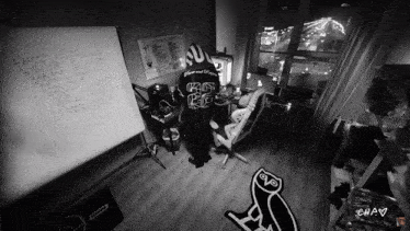 a black and white photo of a room with a whiteboard that says " i wanna "