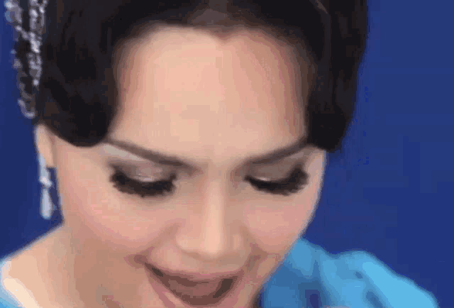 a close up of a woman 's face with long eyelashes