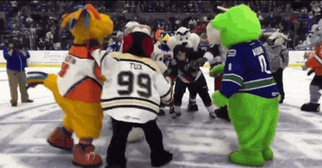 a group of mascots including tux number 99 are standing on a ice rink