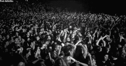 a black and white photo of a crowd of people with post-america written on the bottom left