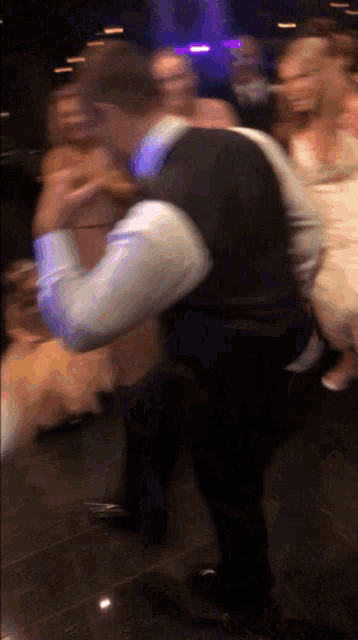 a blurry picture of a man in a suit dancing