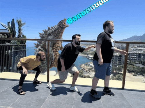 three men are standing on a balcony with a monster in the background that says onwww