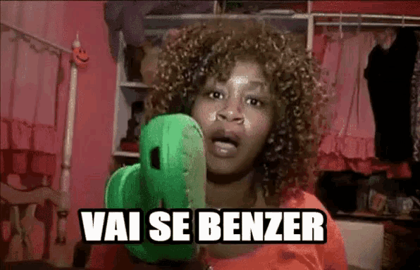 a woman with curly hair is holding a green cactus and says vai se benzer .