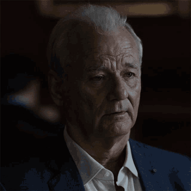 a close up of a man 's face with a serious look on his face
