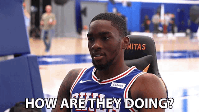 a basketball player sitting in a chair with the words how are they doing written below him