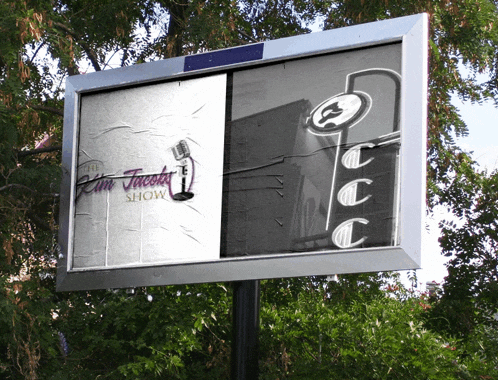 a billboard for the kim tucker show is hanging on a pole
