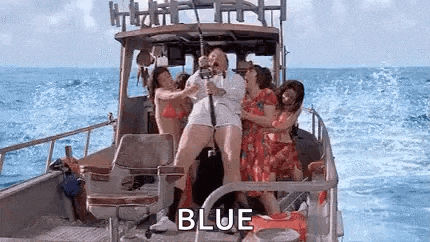 a group of women are standing on a boat in the ocean holding fishing rods .