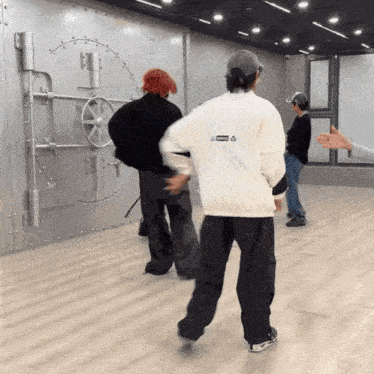 a man in a white jacket with the word supreme on the back is dancing