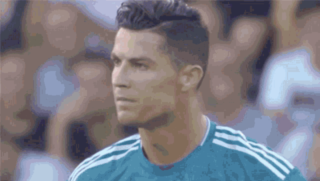 a close up of a soccer player wearing a green jersey