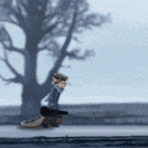 a person is standing in front of a tree in a foggy day .