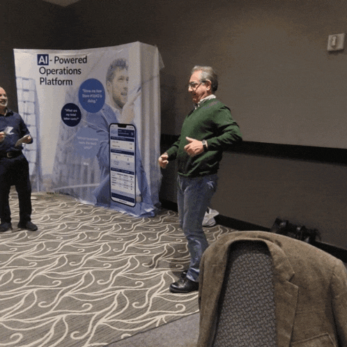 a man stands in front of a sign that says ' ai-powered operations platform '