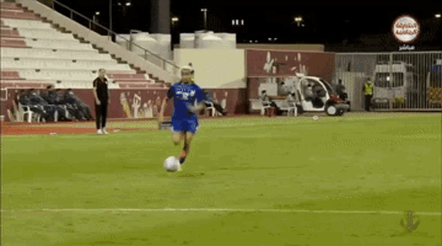 a soccer player kicking a ball on a field with a sign that says ' ambulance '