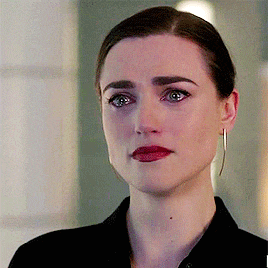 a close up of a woman 's face with a tear running down her cheek .