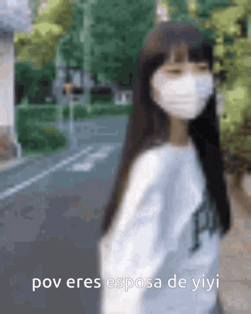a blurry picture of a woman wearing a mask with the words pov eres esposa de yiyi below her .