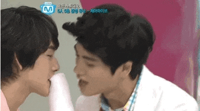a couple of men are kissing each other on the cheeks .