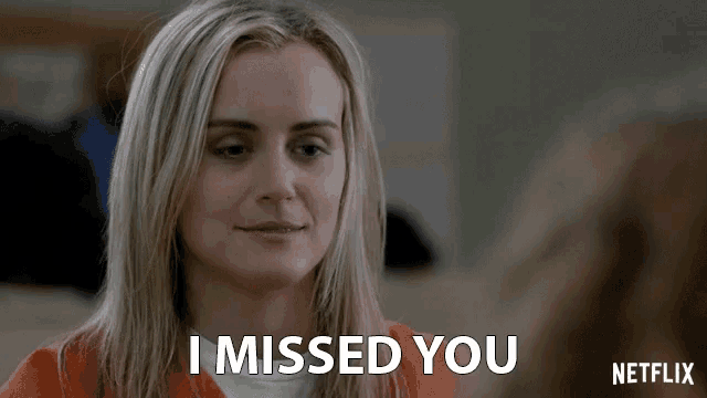 a blonde woman in an orange shirt says i missed you