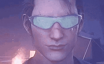 a close up of a man wearing sunglasses with a fire in the background .