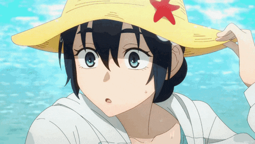 a close up of a girl wearing a yellow hat with a red flower on it