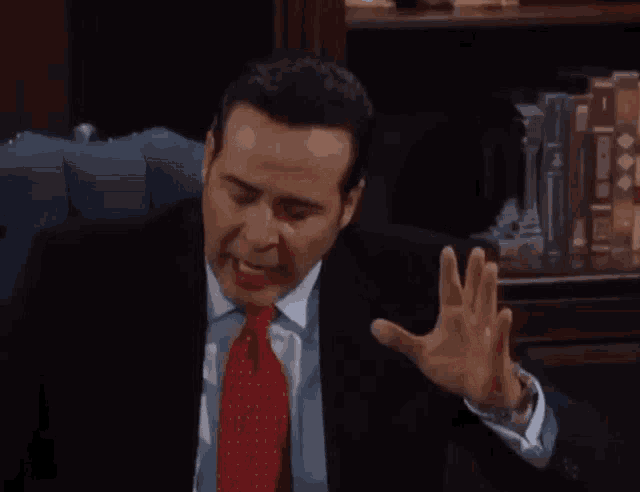 a man in a suit and tie is making a funny face
