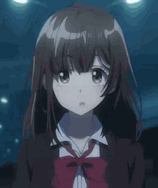 a close up of a girl with her eyes closed wearing a school uniform and tie .