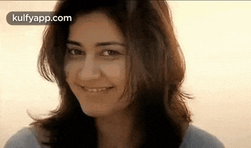 a close up of a woman 's face smiling .