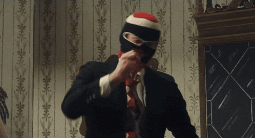 a man in a suit has a mask on his face